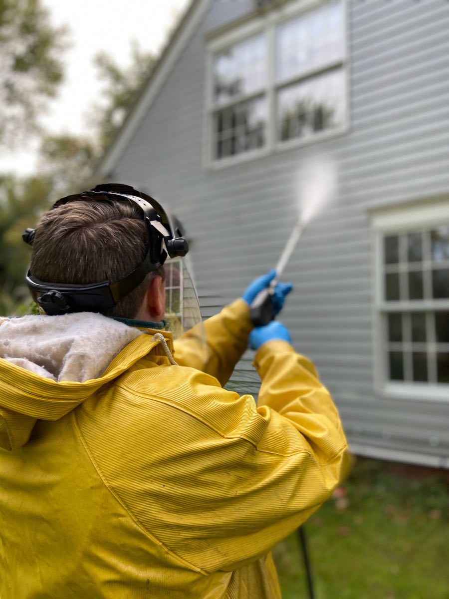 ZeroPressure technician soft washing the siding of a two-story home in Nashville